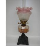 A good Victorian oil lamp with cranberry tint to shade.