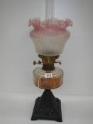 A good Victorian oil lamp with cranberry tint to shade.