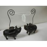 2 ceramic pocket watch stands in the form of flying pigs.