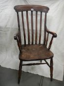 A Victorian slat back Windsor arm chair.