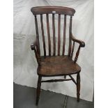 A Victorian slat back Windsor arm chair.