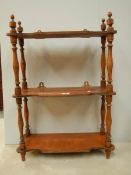 A 3 shelf oak book rack with original turnings and finials, 29" tall.