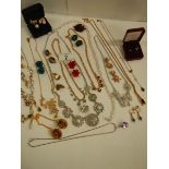 A mixed lot of costume jewellery including necklaces, earrings, brooches etc.