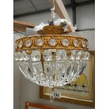 A good quality brass and glass chandelier 12" diameter x 11" drop.