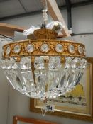 A good quality brass and glass chandelier 12" diameter x 11" drop.