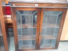 An oak 2 door leaded book case, 35" wide x 38" high,