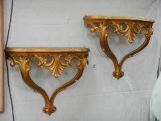 A pair of gilded wall brackets.