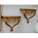 A pair of gilded wall brackets.