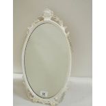 A mid 20th century metal framed oval mirror, in good condition (19" tall).