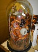 A Victorian fruit display under glass dome.