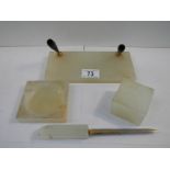 A 4 piece onyx desk set including paperweight, letter opener, ashtray (slight chip) etc.