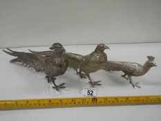 A pair of silver plated pheasants and one other.