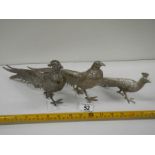 A pair of silver plated pheasants and one other.