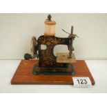 A miniature hand operated sewing machine, made in Germany.