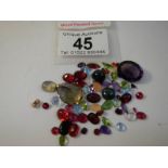 A mixed lot of loose gem stones including rubies, approximately 50 in total.