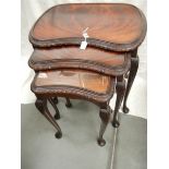 A nest of 3 mahogany tables on cabriole legs.