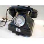 A vintage black bakelite telephone converted for use.