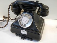 A vintage black bakelite telephone converted for use.