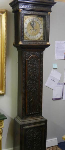A heavily carved 8 day brass faced Grandfather clock by Geo. Raphams, Brigg.