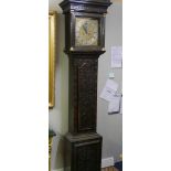 A heavily carved 8 day brass faced Grandfather clock by Geo. Raphams, Brigg.