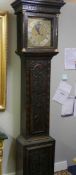 A heavily carved 8 day brass faced Grandfather clock by Geo. Raphams, Brigg.