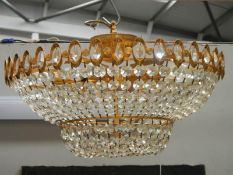 A good quality brass and glass chandelier, 24" diameter x 15" drop.