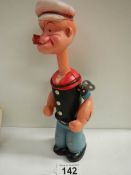 A vintage clockwork figure of Popeye, in working order.