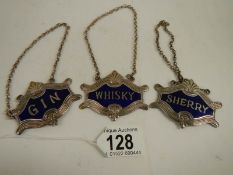 A set of 3 plated and enamel wine labels.