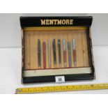 A Mentmore fountain pen display case with some pens, back drops down, 12" wide.