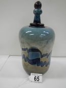 A very unusual studio glass stoppered jar, 8.5" tall, in good condition.