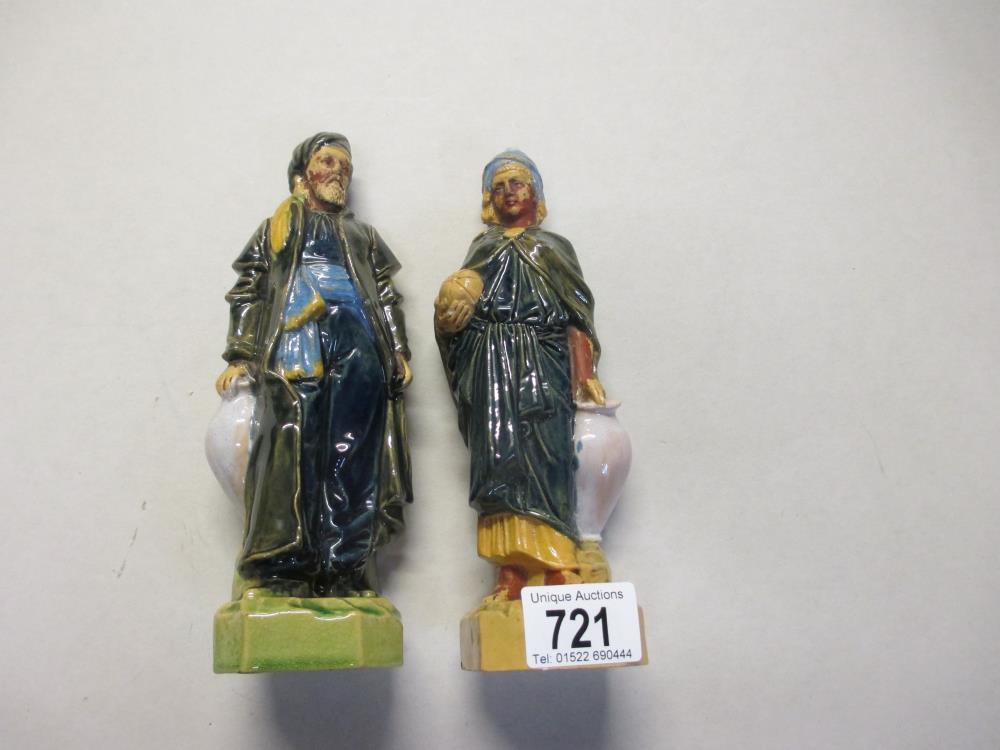 A pair of old male / female waterbearer figures