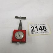 A silver and enamel ladies fob watch with marcasite pin.