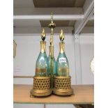 A good quality Victorian 3 bottle gilded tantalus with green glass bottles, in good condition.