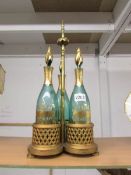 A good quality Victorian 3 bottle gilded tantalus with green glass bottles, in good condition.