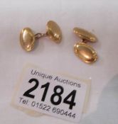 A pair of 18ct gold cuff links, marked '18', approximately 12 grams.