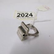 An unusual abstract silver ring with textured silver shank, dated 1981, size L.