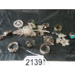 A selection of silver brooches and rings etc