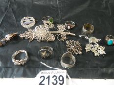 A selection of silver brooches and rings etc