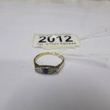 An 18ct marquis shaped sapphire and diamond ring, size N. (unmarked).