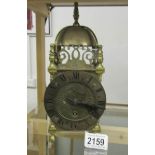 A brass lantern clock.