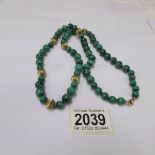 A graduated malachite necklace with gold crab claw clasp (approximate length 70 cm)