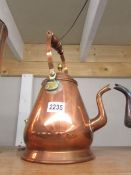 An unusual shaped copper kettle with brass fittings.