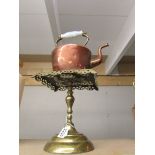 A Copper kettle on a Victorian brass trivet.