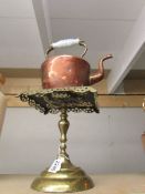 A Copper kettle on a Victorian brass trivet.