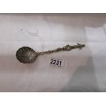 A decorative spoon with figure finial.