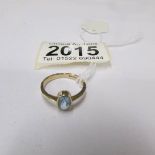 A yellow gold ring set pale blue stone, size M.