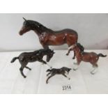 A Beswick horse, a Beswick foal and 2 other horses.