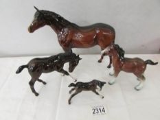 A Beswick horse, a Beswick foal and 2 other horses.