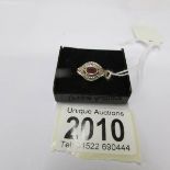 An 18ct gold ruby and diamond ring, size I half.