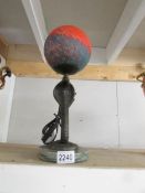 A heavy bronze table lamp in the form of a cobra on marble base with coloured glass globe shade.